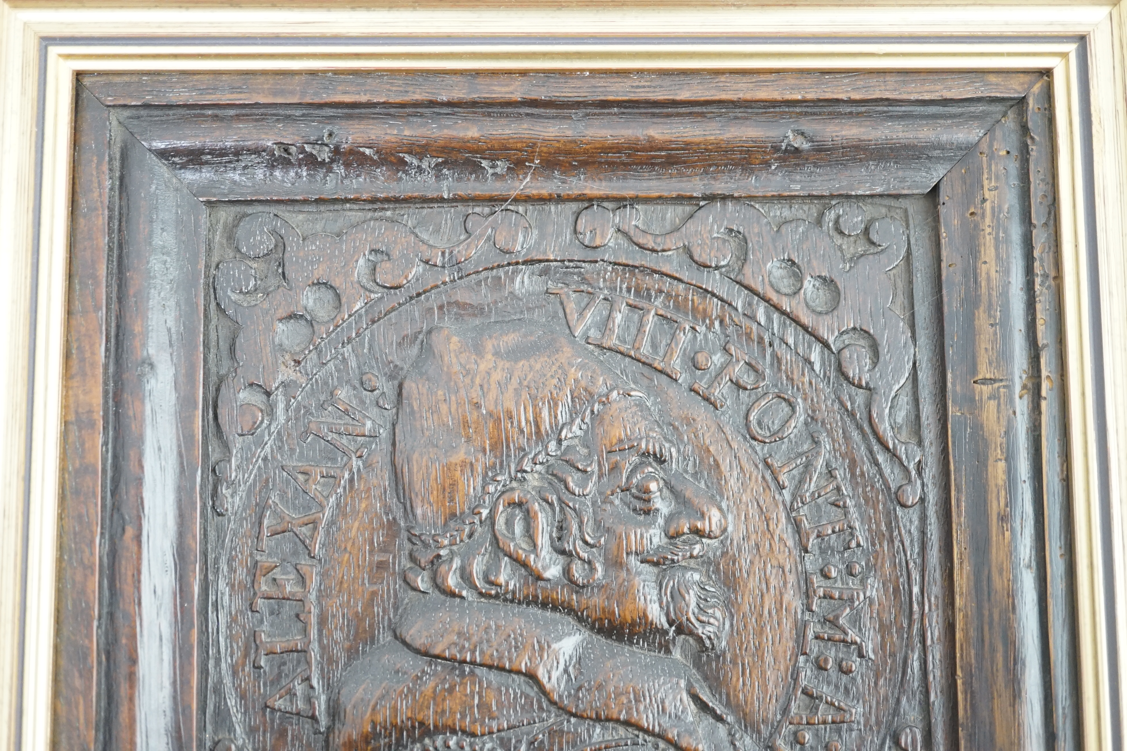 A 17th century oak panel carved with a relief portrait of Pope Alexander VII